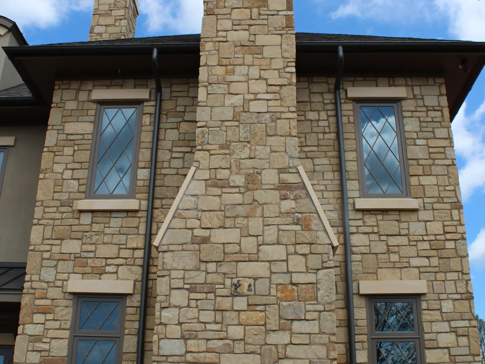 Completed home exterior featuring Chestnut Cream natural stone